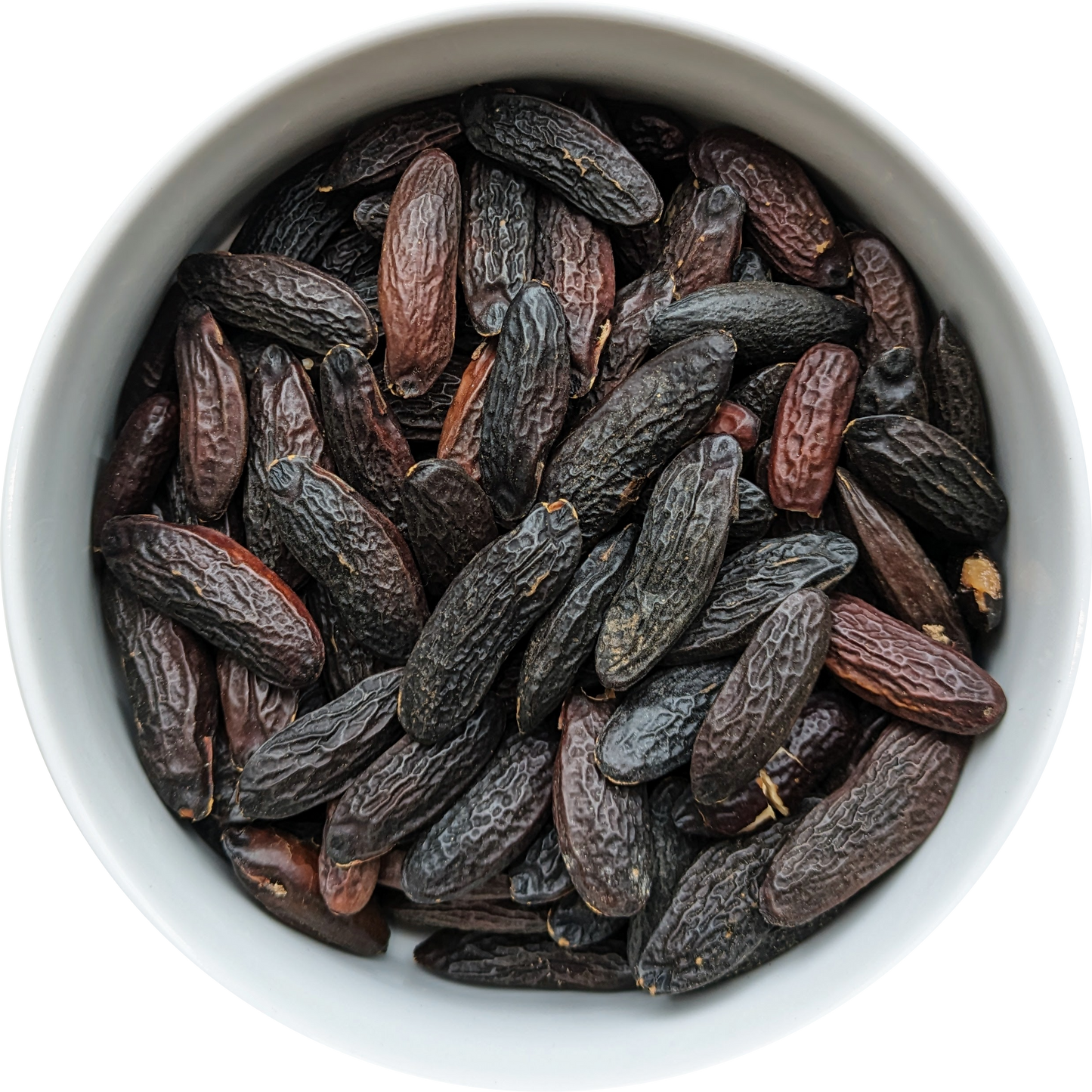 Whole dried Tonka Beans — dark aromatic seeds suitable for ritual craft, incense, and perfumery. Herbal Monkey