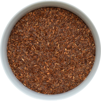 Brewed Rooibos tea with deep amber colour in a clear glass cup