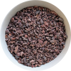 Dark, roasted cacao nibs in a bowl, showing their natural texture and chocolate‑rich appearance Herbal Monkey