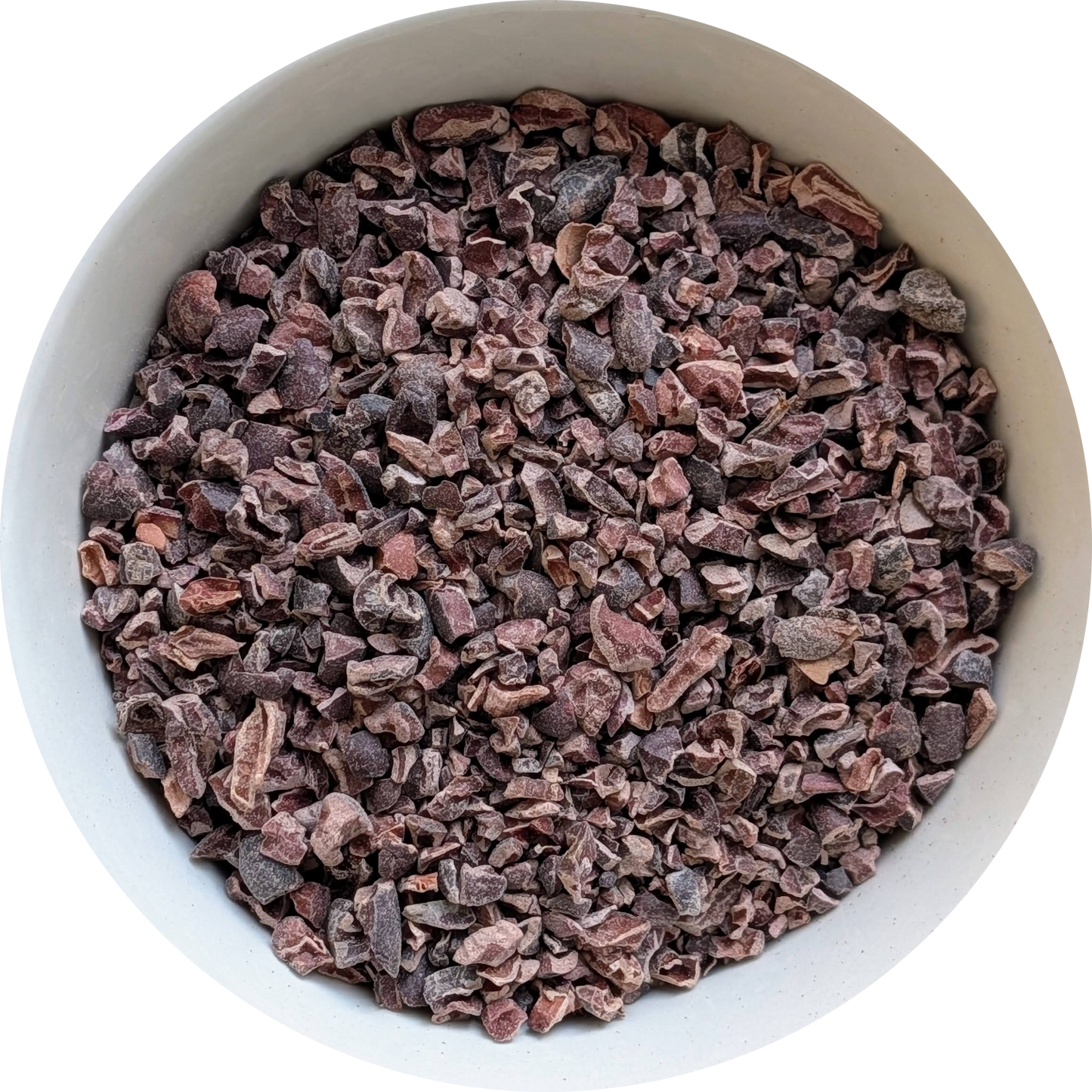 Dark, roasted cacao nibs in a bowl, showing their natural texture and chocolate‑rich appearance Herbal Monkey