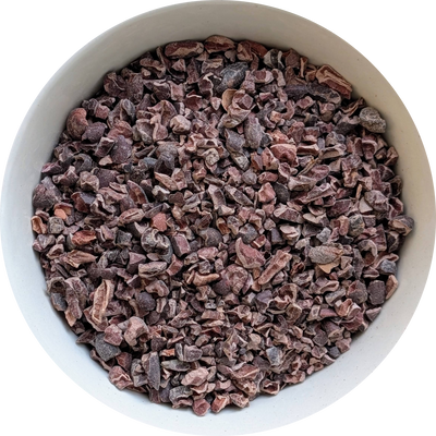 Dark, roasted cacao nibs in a bowl, showing their natural texture and chocolate‑rich appearance