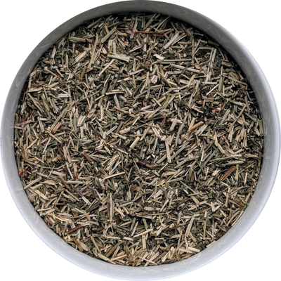 Close-up of dried cut Hyssop herb showing fine green-grey leaf and stem pieces for Hyssop tea
