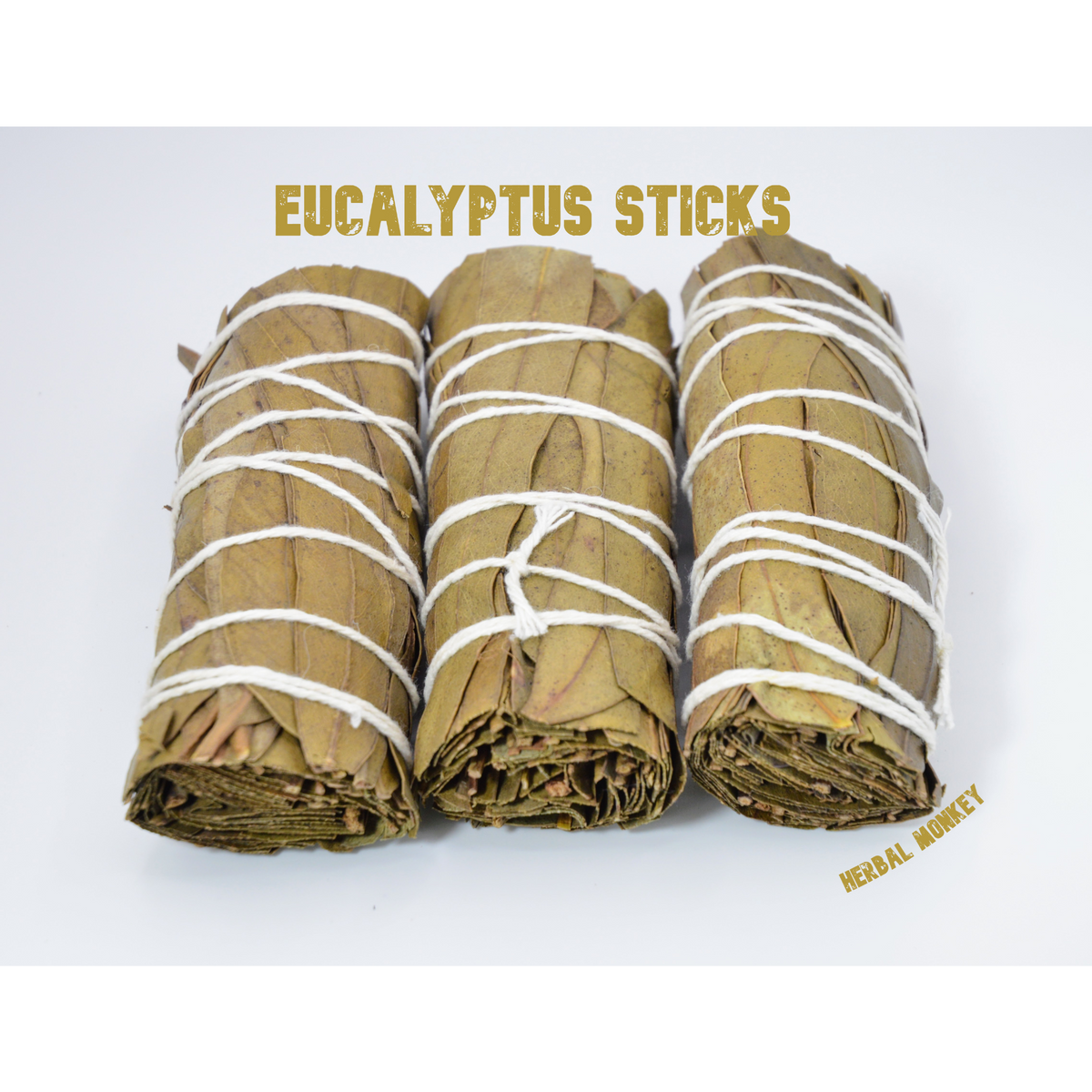 Three Eucalyptus smudge sticks made from dried eucalyptus leaves, hand tied with white cotton string