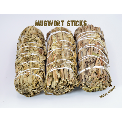 Close-up of three hand-tied Mugwort smudge sticks showing the dried leaves and stems