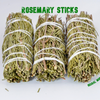 Close-up of three hand-tied Rosemary smudge sticks on a white background