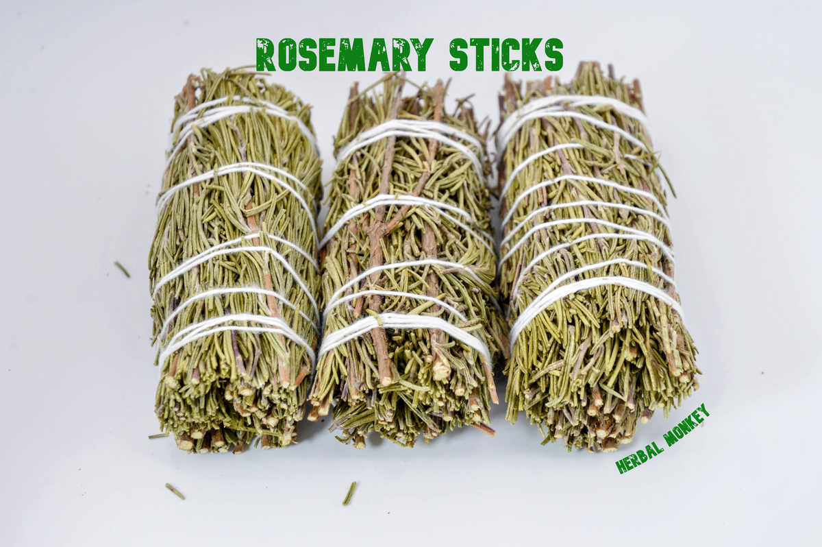 Close-up of three hand-tied Rosemary smudge sticks on a white background