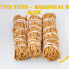 Close-up of three hand-tied Madagascar Vetiver root smudge sticks on a white background