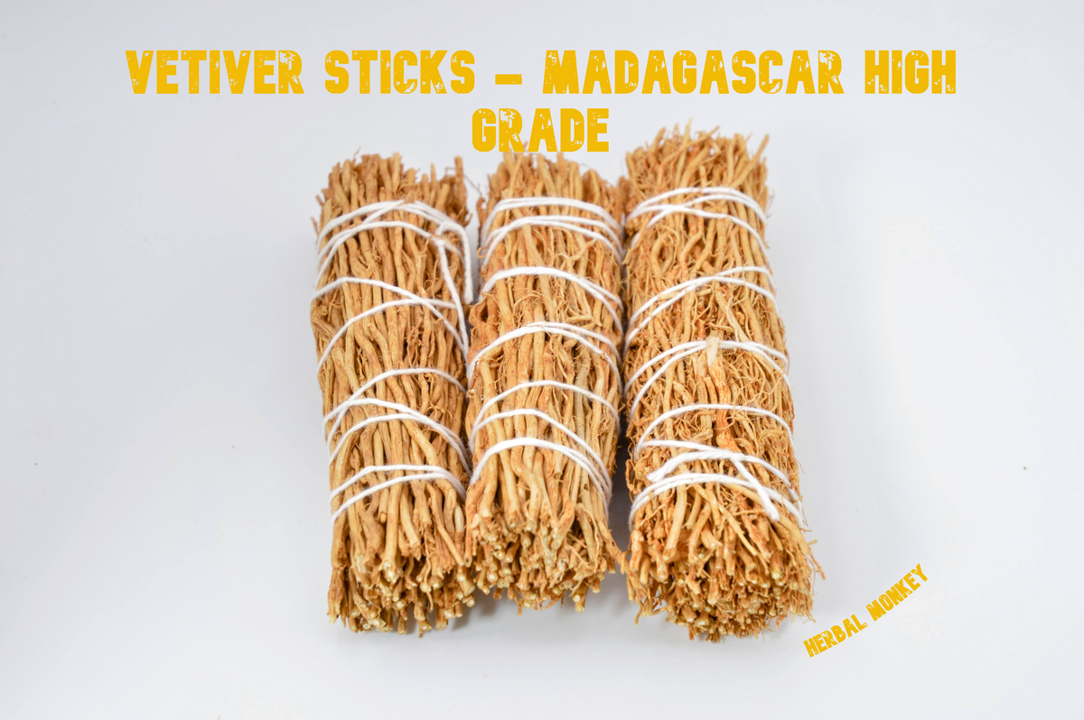 Close-up of three hand-tied Madagascar Vetiver root smudge sticks on a white background