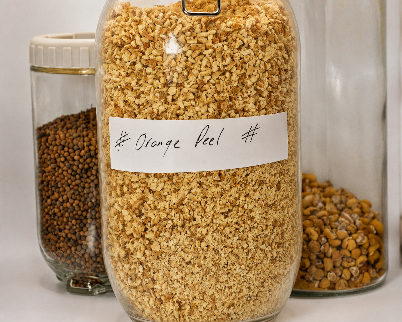 Hand-labelled apothecary jars of dried orange peel and whole botanicals at Herbal Monkey, the UK's independent herbal apothecary